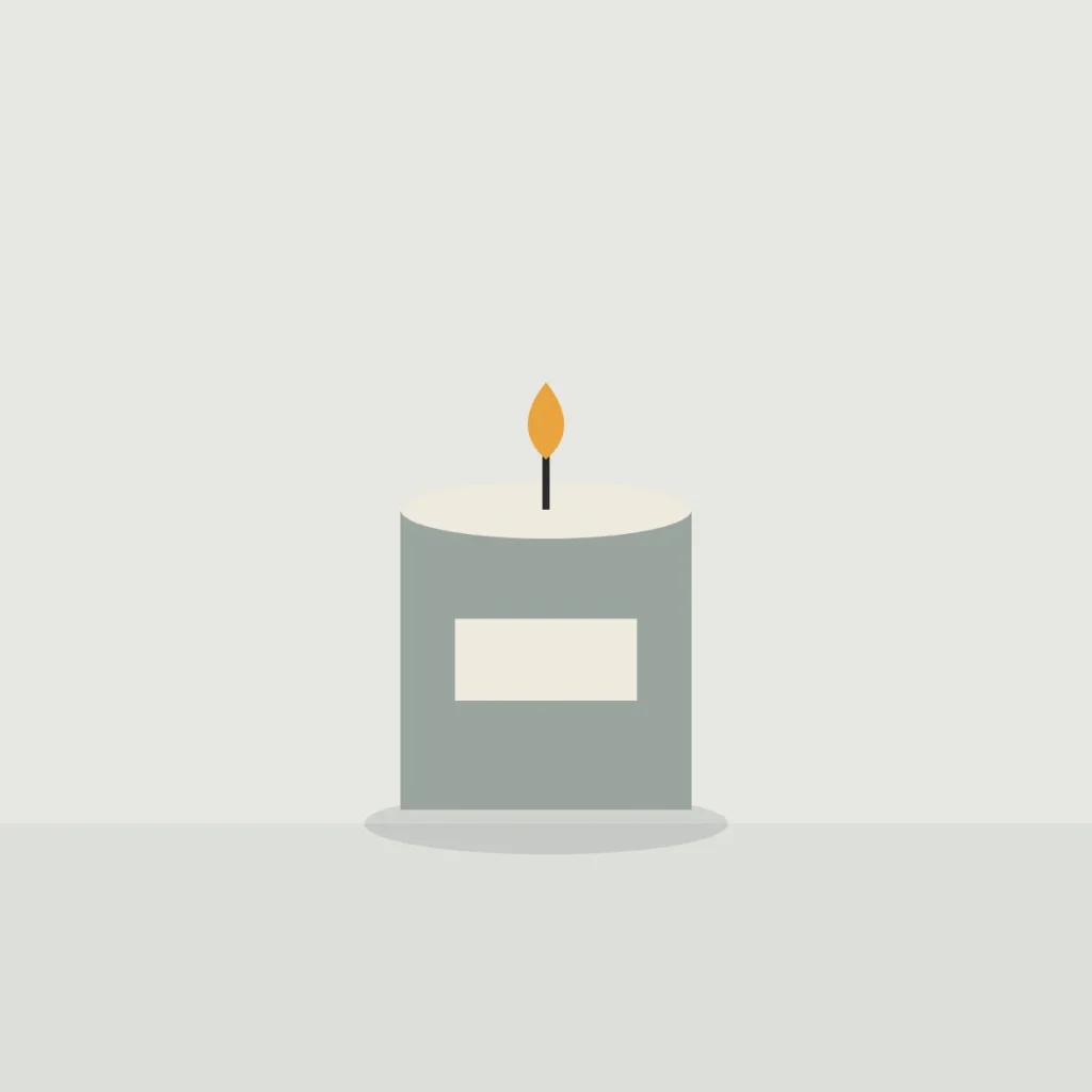 Lit candle in a grey concrete pot