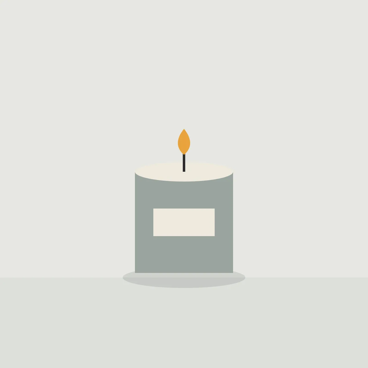 Lit candle in a grey concrete pot