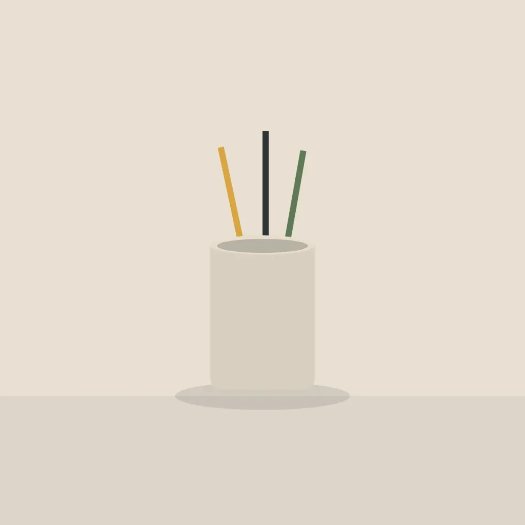 Sand coloured stoneware cup holding three pencils