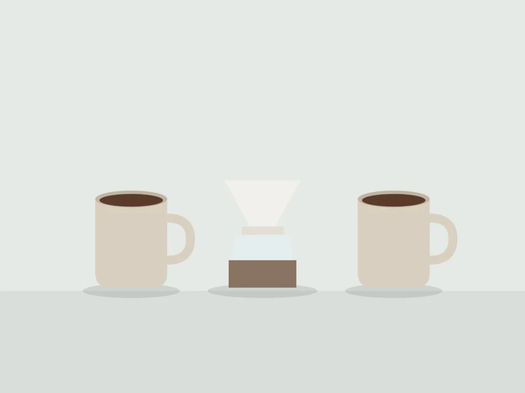 Two stoneware mugs either side of a porcelain pour-over dripper