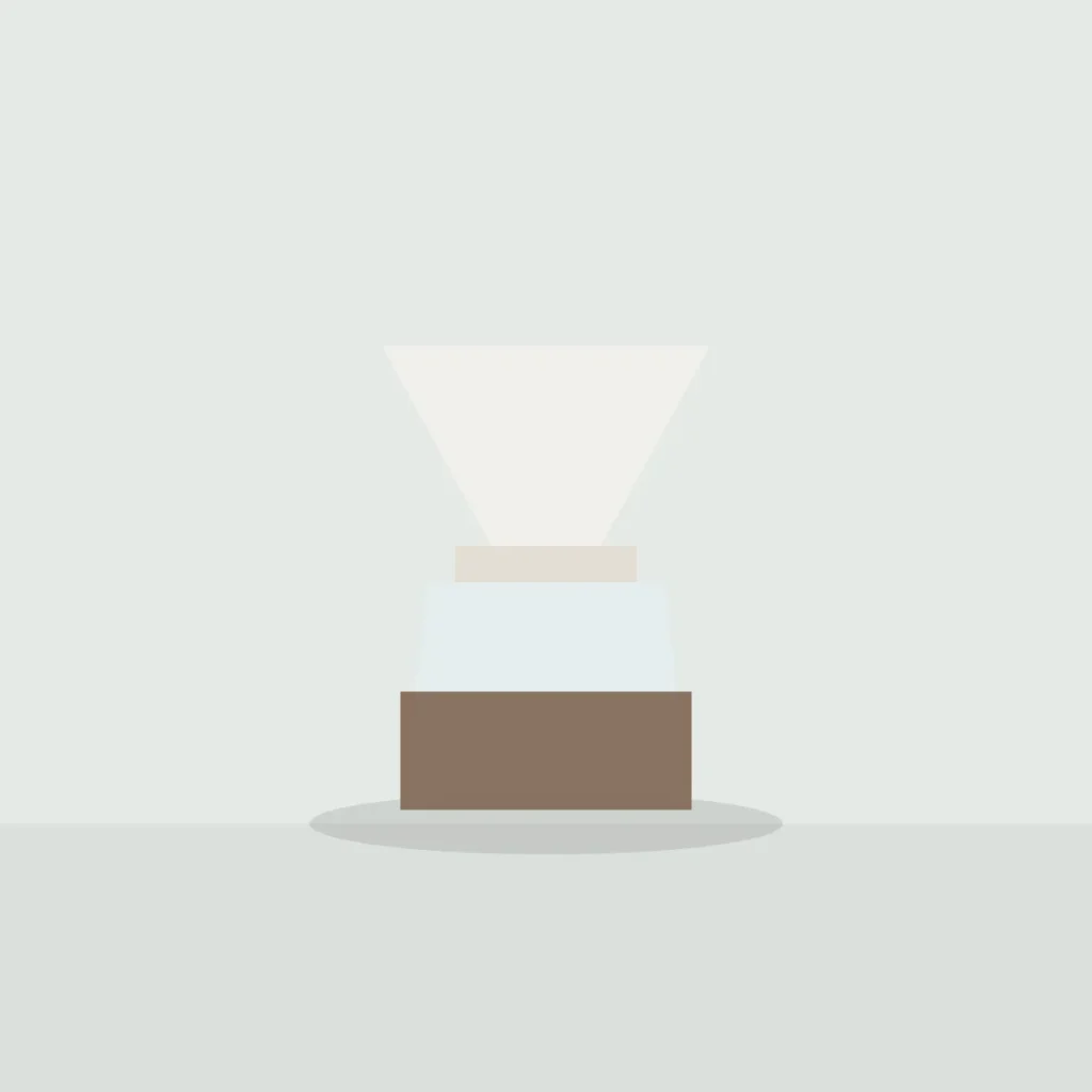 White porcelain dripper on a glass coffee server